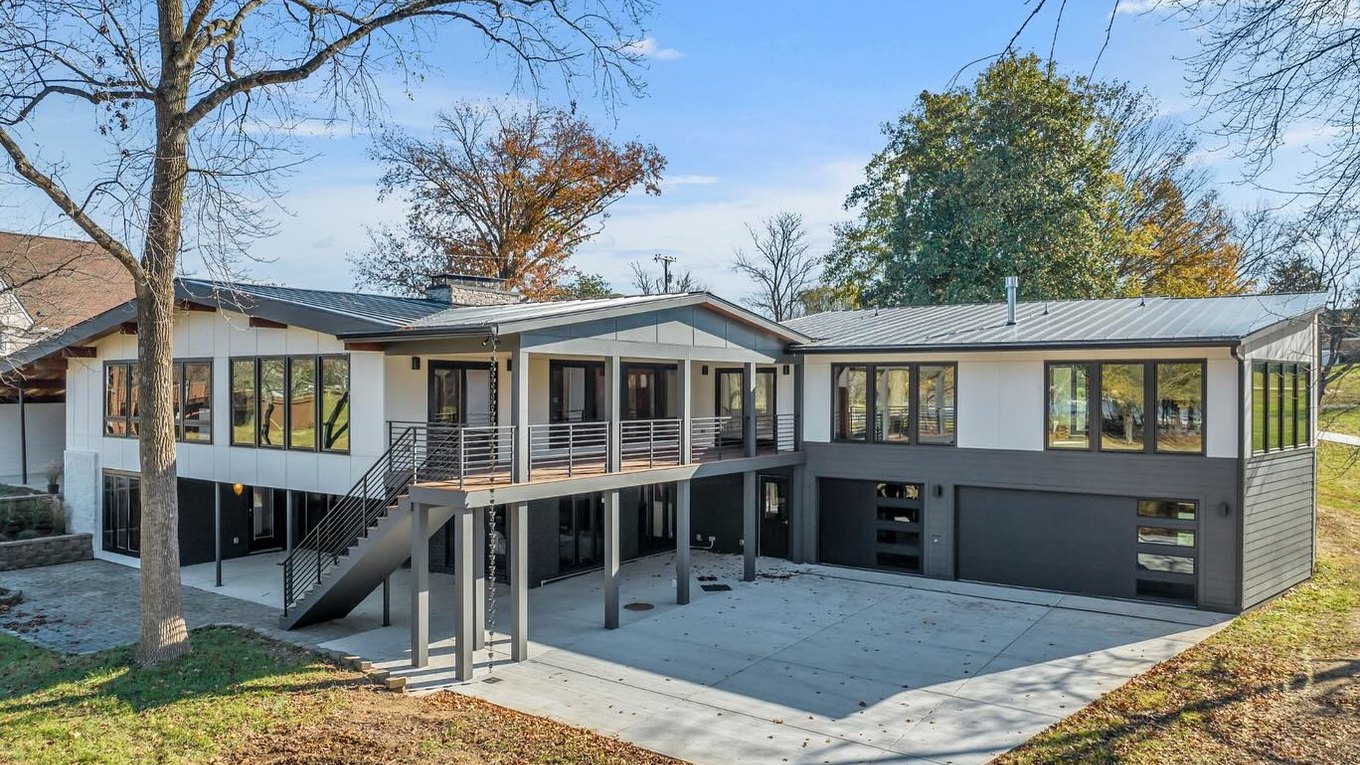 A low slung mid century house with a long band of windows, seen from the garden.